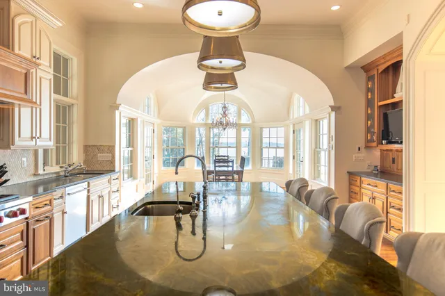 a spacious bedroom with a bed and wooden floor