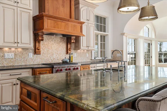 a bathroom with a granite countertop sink a mirror and a shower