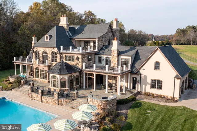 an aerial view of a house with outdoor space