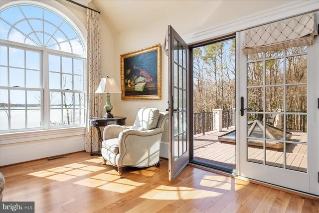 an aerial view of lake residential house with outdoor space and trees around