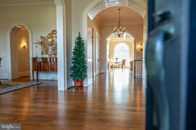 a kitchen with stainless steel appliances granite countertop a refrigerator a stove and white cabinets with wooden floors