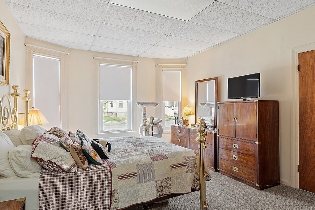 2 Bond Place Saugus, MA 01906 - Photo 14 of 42 a bedroom with a bed a television and dresser