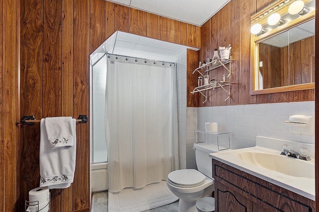 2 Bond Place Saugus, MA 01906 - Photo 16 of 42 a bathroom with a sink a toilet and shower curtain