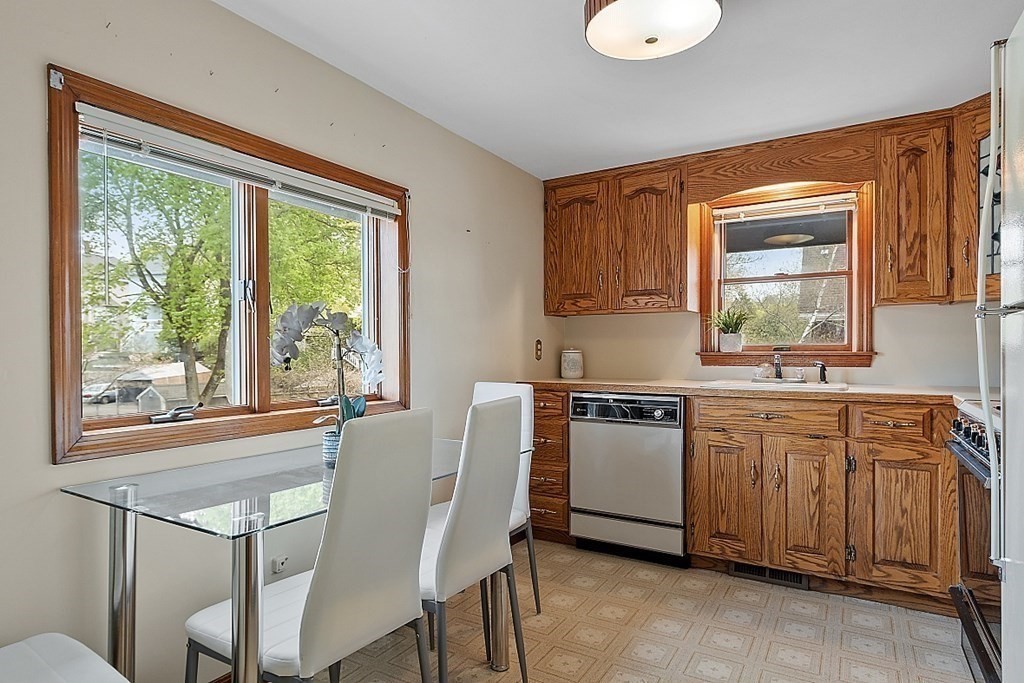 2 Bond Place Saugus, MA 01906 - Photo 19 of 42 a kitchen with a table chairs sink and cabinets