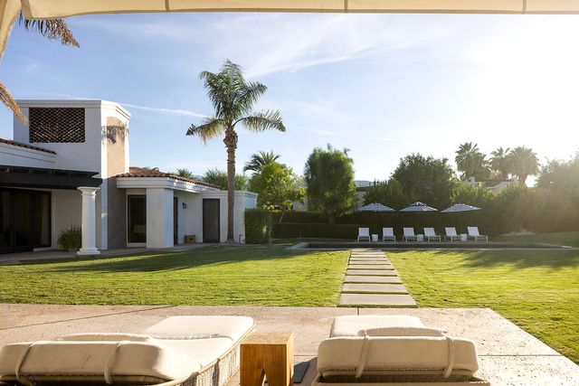 a front view of a house with a garden and porch