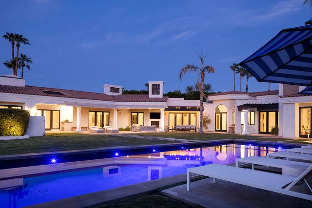 a view of a living room with kitchen