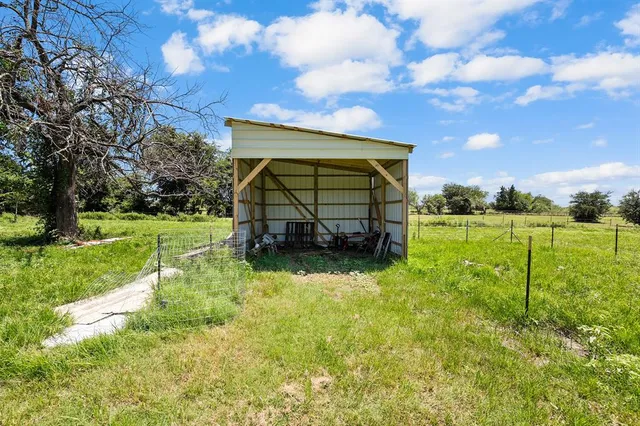 a view of backyard with wooden fence