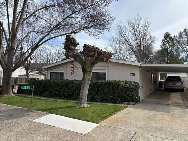 a front view of house with yard and trees