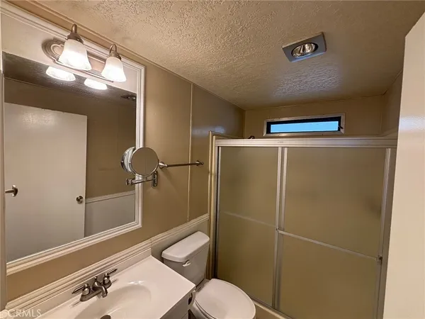 a bathroom with a shower a toilet and sink
