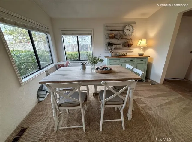 a view of a dining room with furniture and window