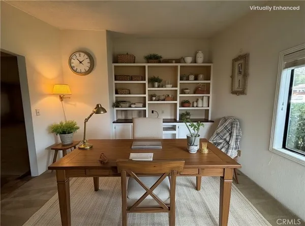 a view of a dining room with furniture and window