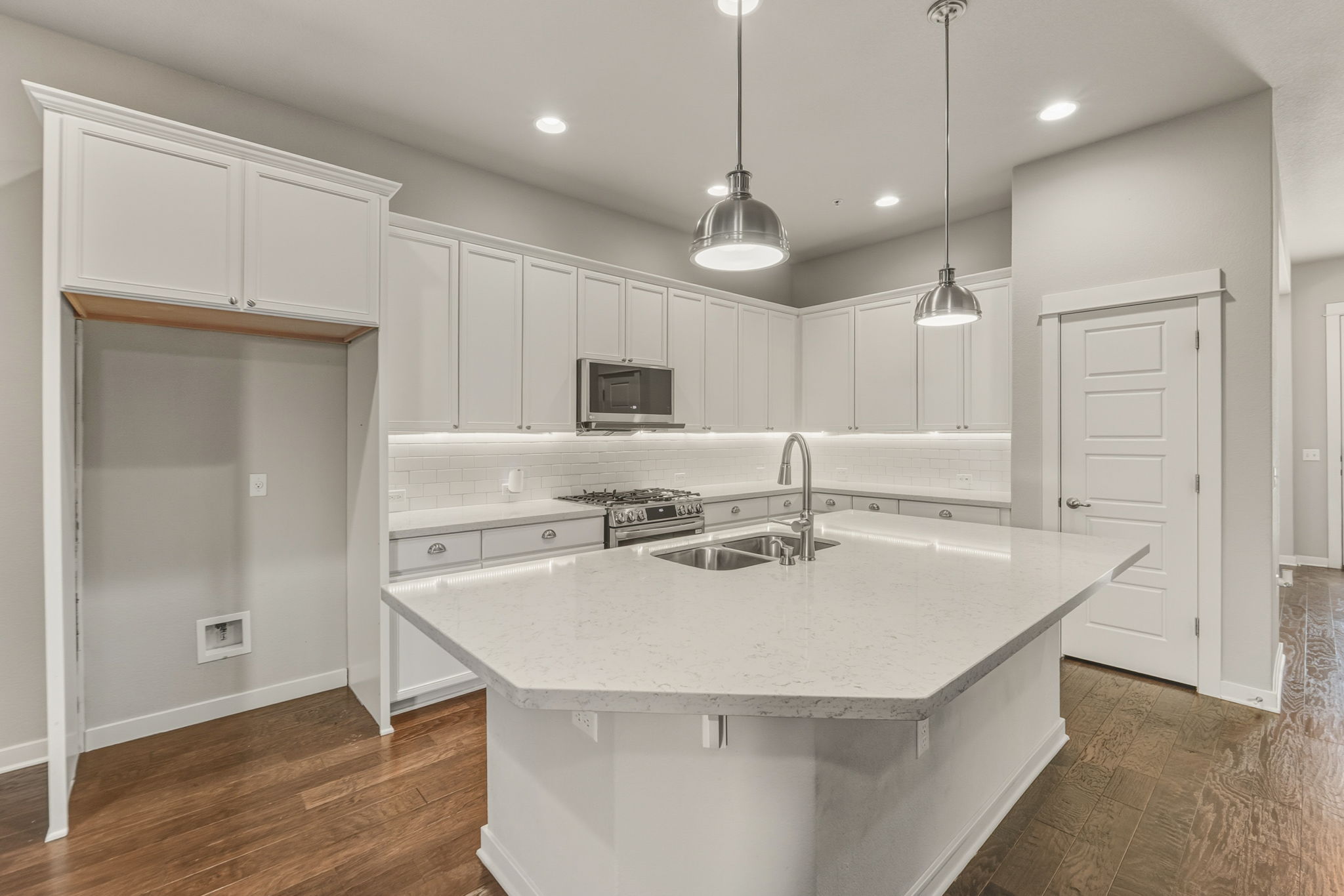 3919 Vaughan Street Austin, TX 78723 - Photo 11 of 40 Culinary dreams come alive in this kitchen, boasting pristine stone counters and rich hardwood flooring.