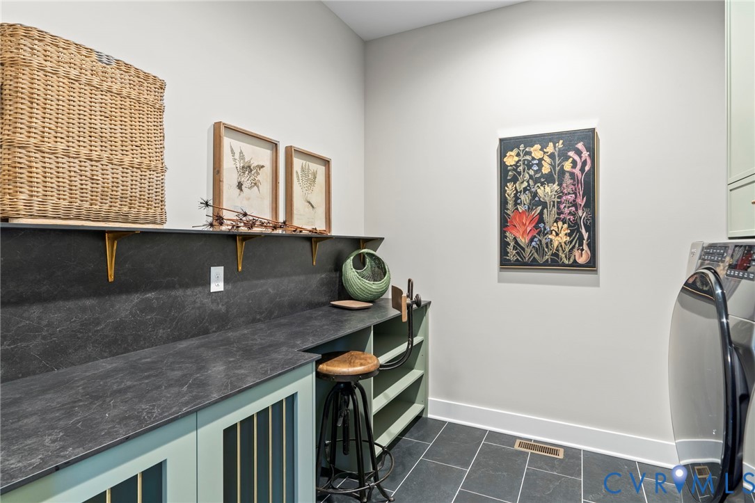 4764 Gooden Trail Quinton, VA 23141 - Photo 14 of 50 Laundry room featuring cabinet space and dark tile