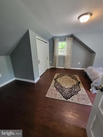 a view of a livingroom with wooden floor and window
