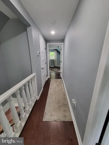 a view of hallway with wooden floor