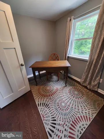 a view of a balcony with wooden floor and a rug
