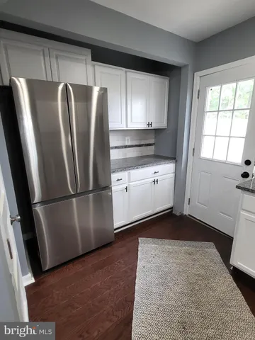 a kitchen with stainless steel appliances a refrigerator sink and cabinets