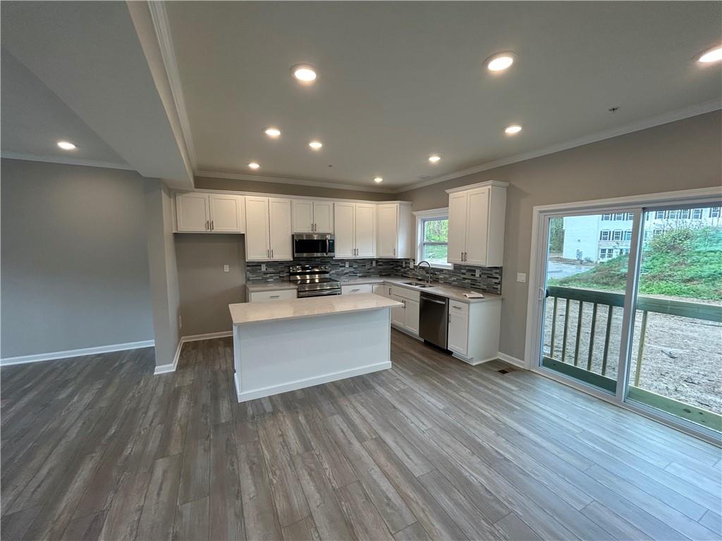 168 Lockheed Drive Coraopolis, PA 15108 - Photo 3 of 6 an open kitchen with wooden floor and stainless steel appliances