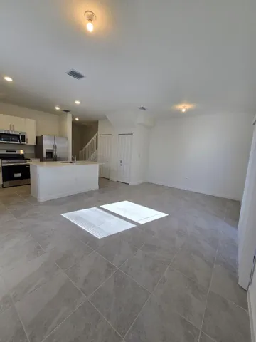 a view of a kitchen with a sink and cabinets