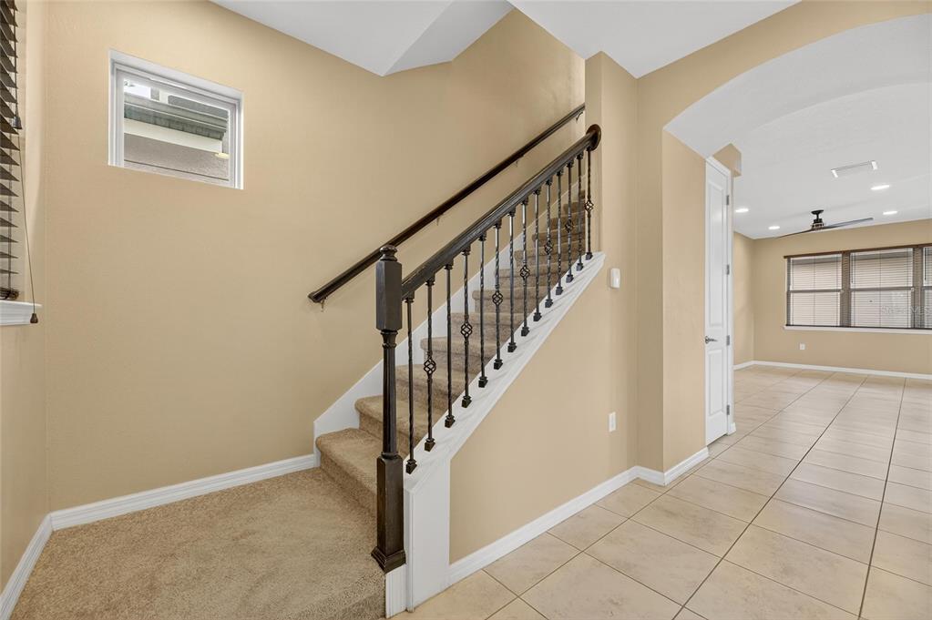 5811 Caldera Ridge Drive Lithia, FL 33547 - Photo 15 of 44 a view of an entryway with wooden floor leading to a furnished livingroom and windows