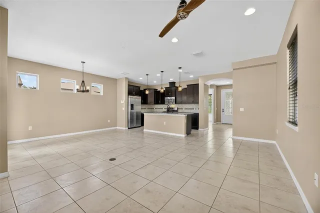 an empty room with closet and windows