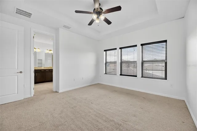 a bathroom with a granite countertop sink a large mirror and a shower