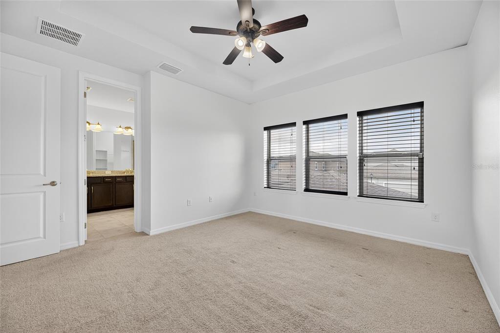 5811 Caldera Ridge Drive Lithia, FL 33547 - Photo 20 of 44 a view of an empty room with a window and a kitchen
