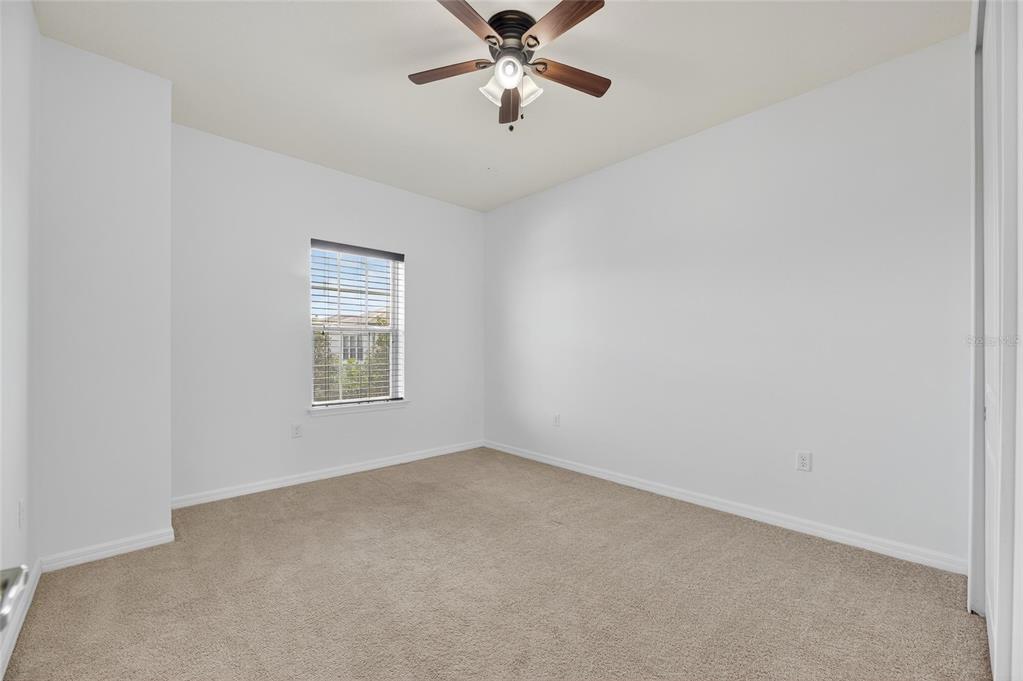 5811 Caldera Ridge Drive Lithia, FL 33547 - Photo 28 of 44 an empty room with a window and a fan