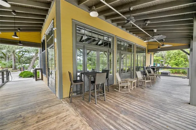 a balcony with wooden floor and fence