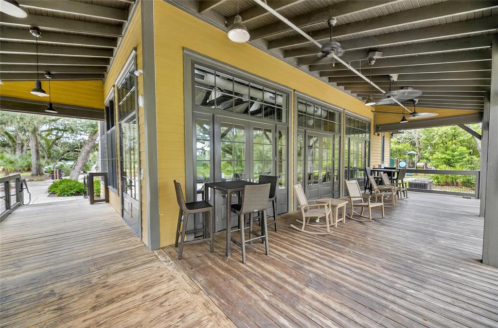 5811 Caldera Ridge Drive Lithia, FL 33547 - Photo 38 of 44 a view of a patio with table and chairs potted plants with wooden floor