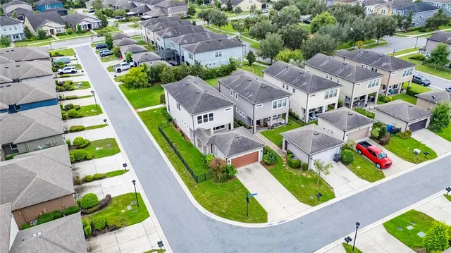a view of a house with a backyard and a patio