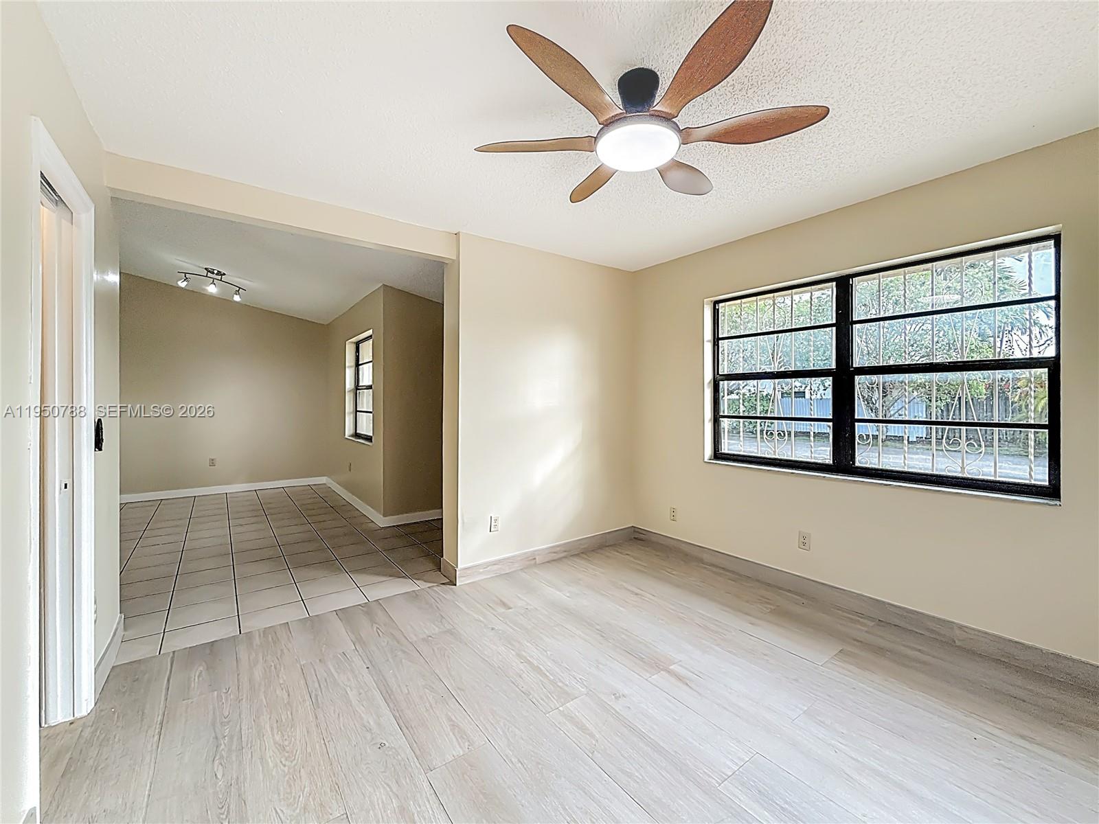 12787 Northwest 10th Lane Miami, FL 33182 - Photo 22 of 48 wooden floor in an empty room with a window