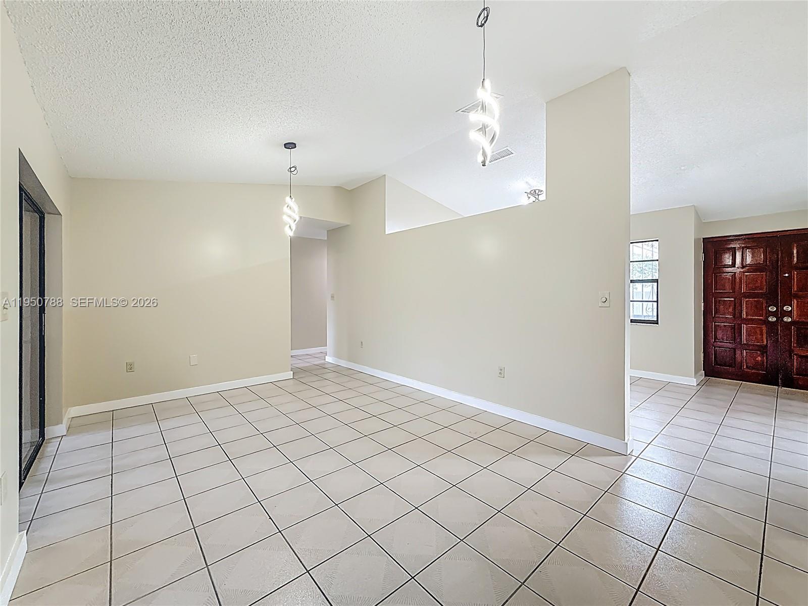 12787 Northwest 10th Lane Miami, FL 33182 - Photo 23 of 48 an empty room with kitchen and window