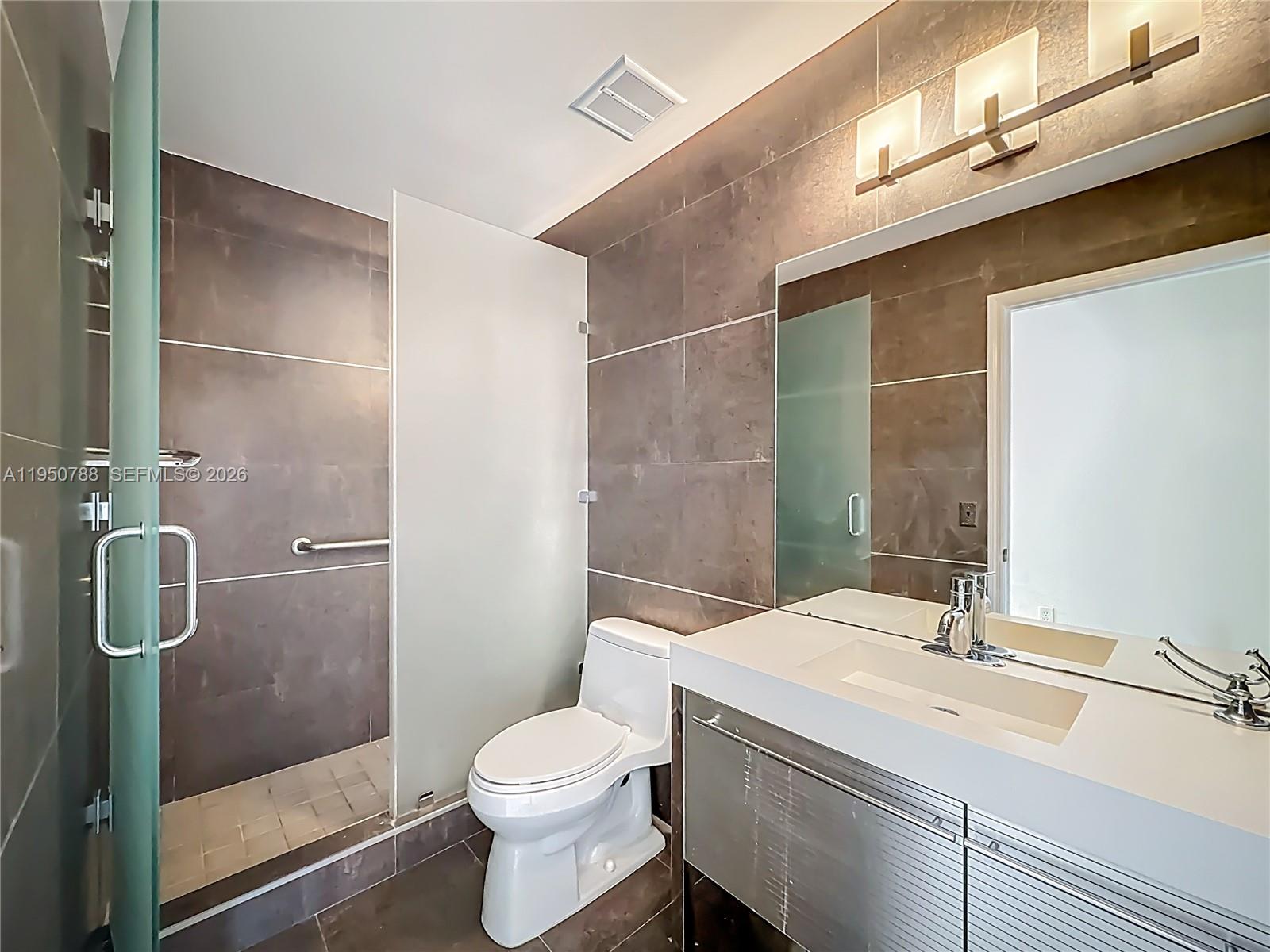 12787 Northwest 10th Lane Miami, FL 33182 - Photo 28 of 48 a bathroom with a sink a toilet and shower