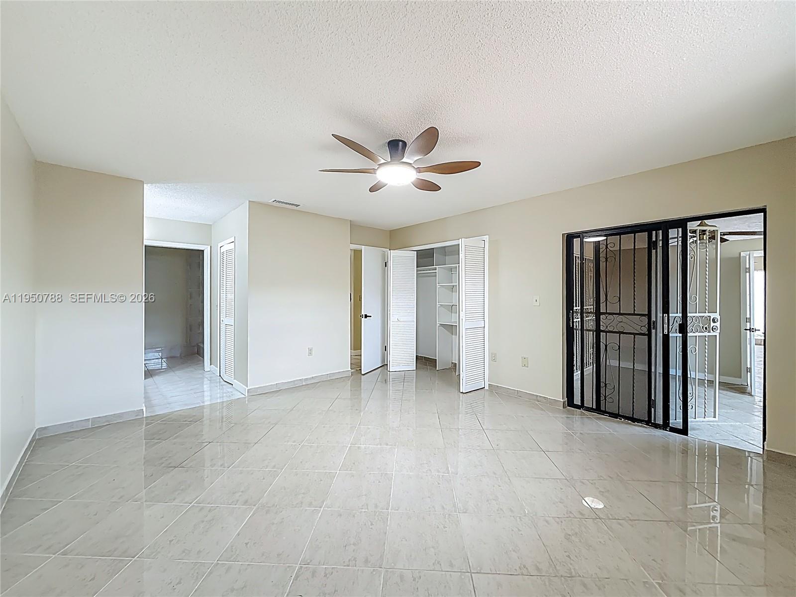 12787 Northwest 10th Lane Miami, FL 33182 - Photo 30 of 48 an empty room with closet and windows