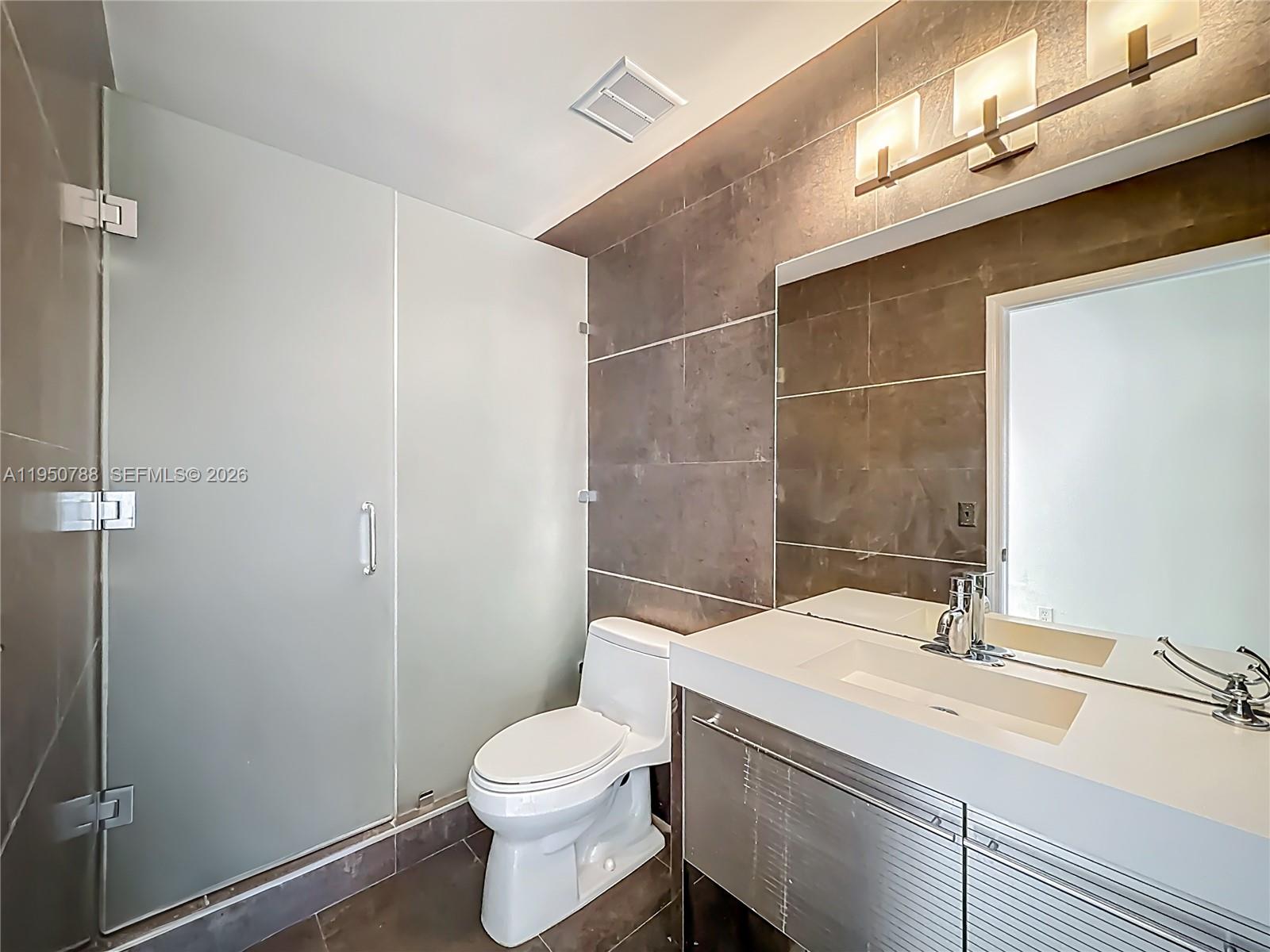 12787 Northwest 10th Lane Miami, FL 33182 - Photo 34 of 48 a bathroom with a sink a toilet and shower