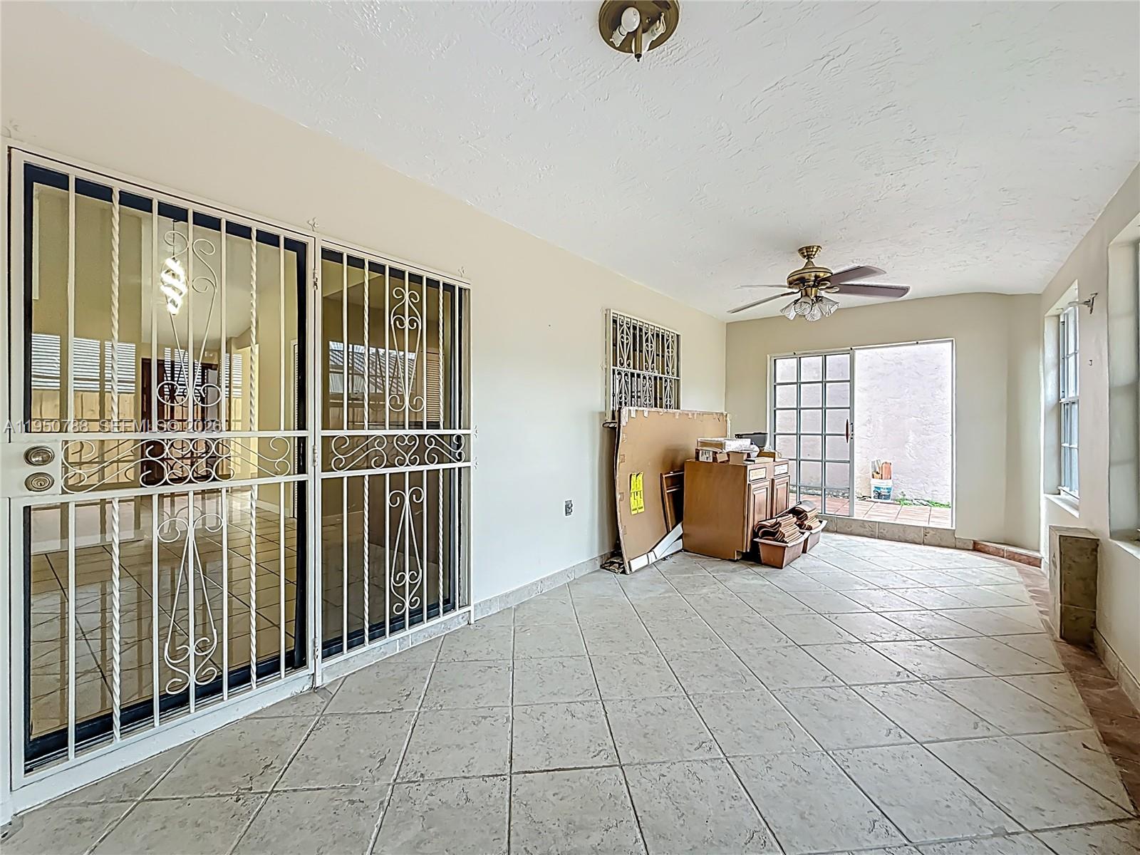 12787 Northwest 10th Lane Miami, FL 33182 - Photo 39 of 48 a view of a livingroom with furniture and a ceiling fan