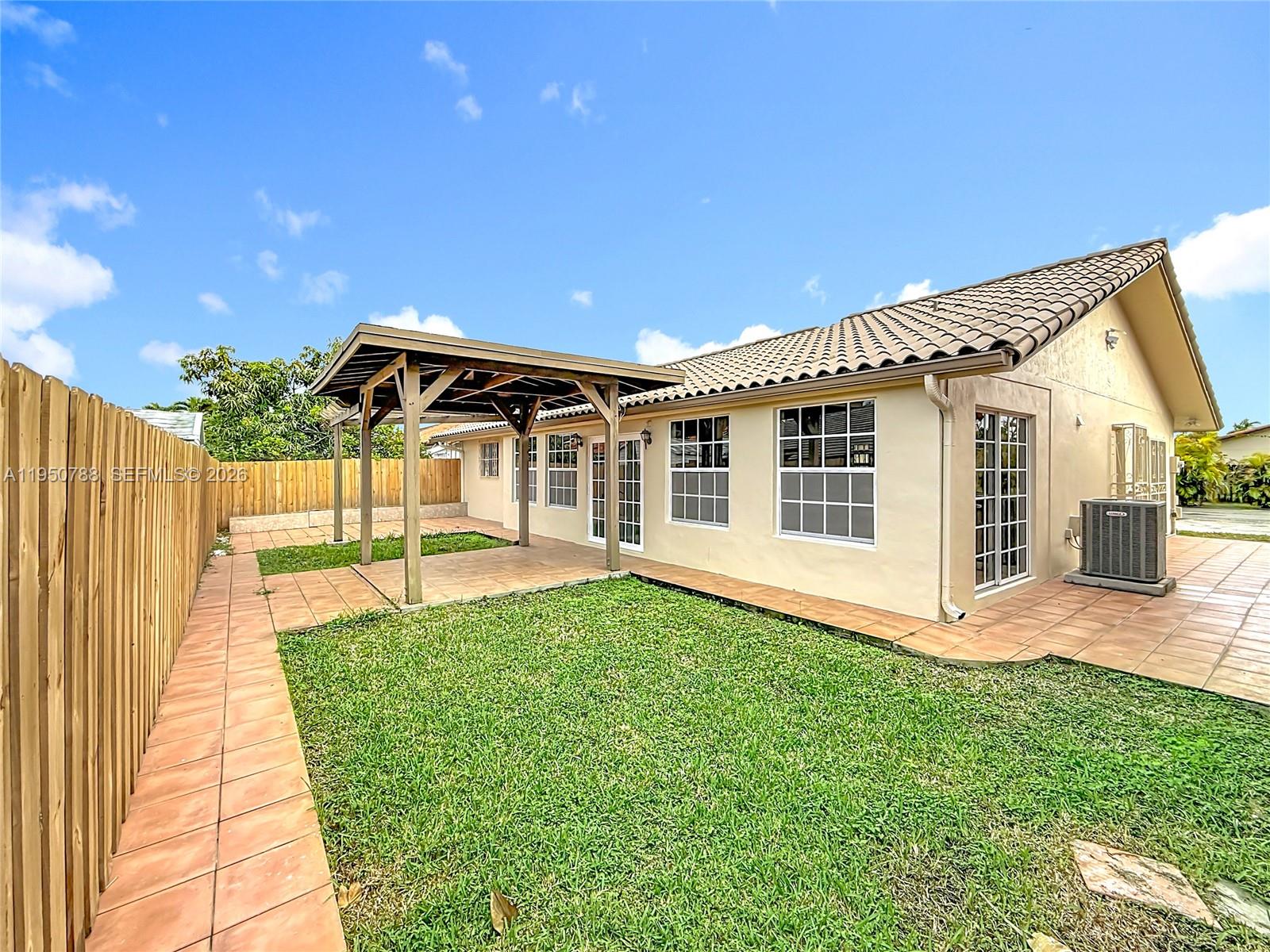 12787 Northwest 10th Lane Miami, FL 33182 - Photo 43 of 48 a front view of a house with a yard