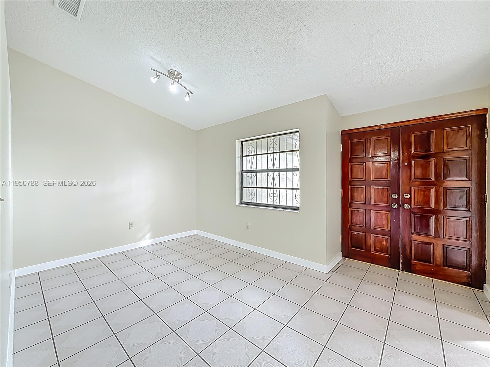 12787 Northwest 10th Lane Miami, FL 33182 - Photo 7 of 48 a view of an empty room and window