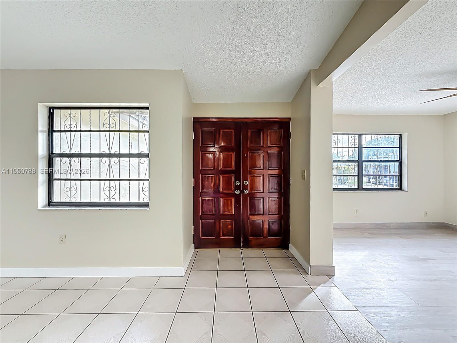 12787 Northwest 10th Lane Miami, FL 33182 - Photo 8 of 48 an empty room with windows