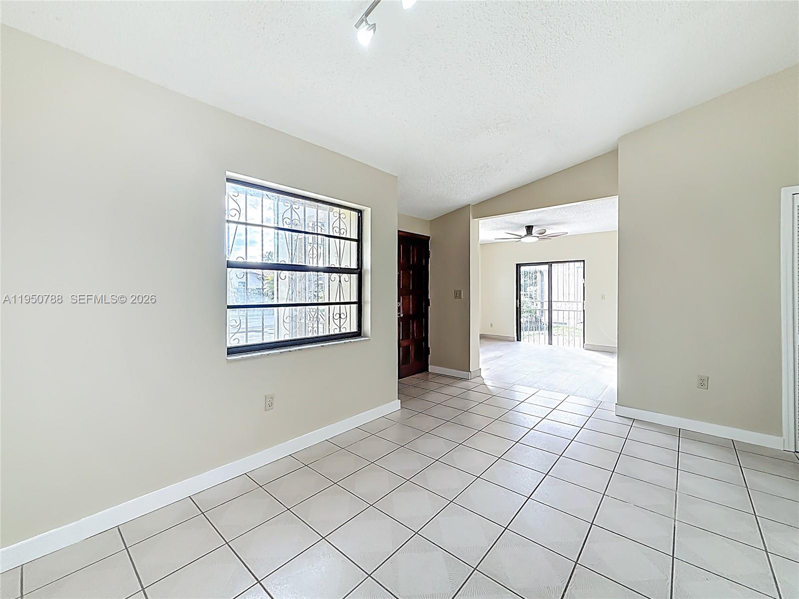 12787 Northwest 10th Lane Miami, FL 33182 - Photo 10 of 48 a view of an empty room with window and cabinet