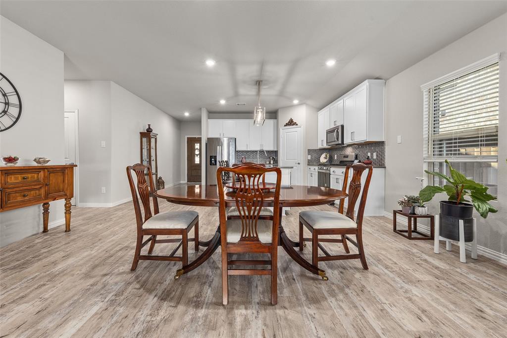 10505 Trail Ridge Drive Fort Worth, TX 76126 - Photo 10 of 37 a dining room with furniture and wooden floor