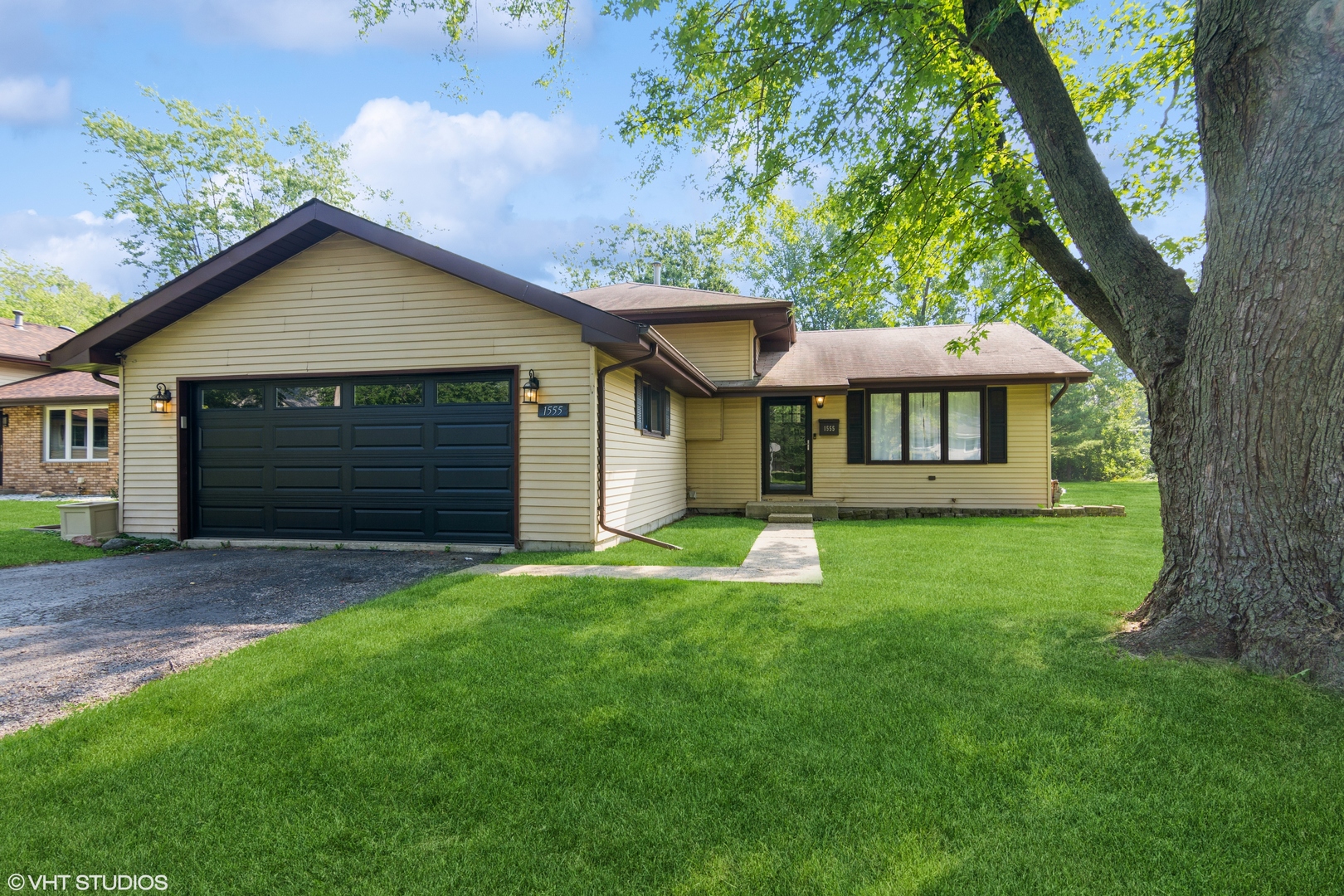 1555 Vincennes Street Crete, IL 60417 - Photo 1 of 18 a front view of a house with a yard and trees