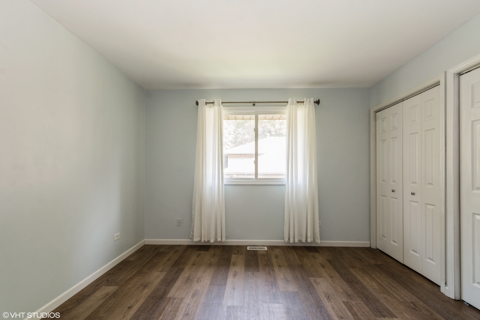 1555 Vincennes Street Crete, IL 60417 - Photo 11 of 18 an empty room with wooden floor and windows