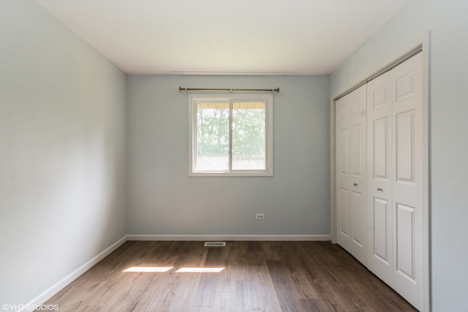 1555 Vincennes Street Crete, IL 60417 - Photo 12 of 18 an empty room with wooden floor and windows