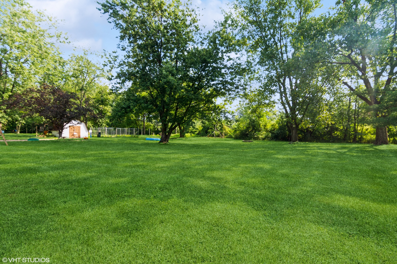 1555 Vincennes Street Crete, IL 60417 - Photo 18 of 18 a view of grassy field with benches and trees all around