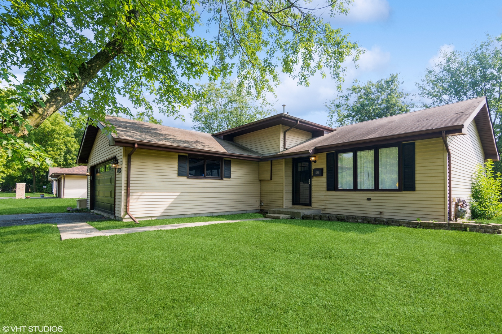 1555 Vincennes Street Crete, IL 60417 - Photo 2 of 18 a view of a house with a yard and a large tree