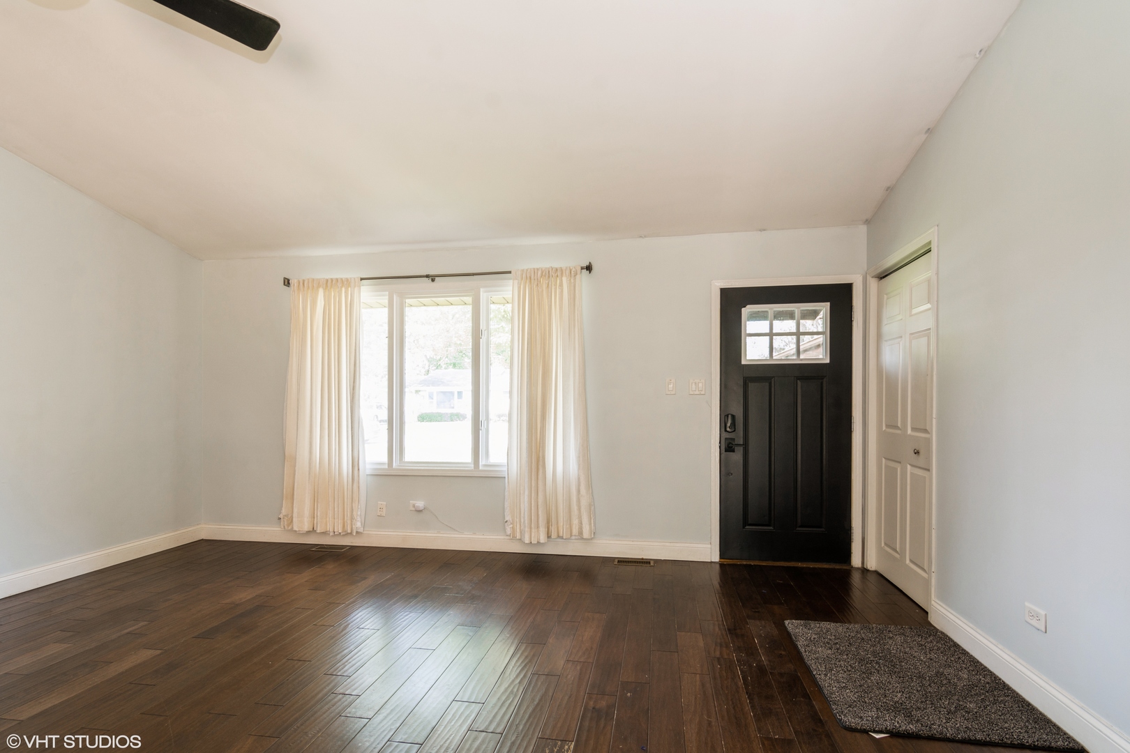 1555 Vincennes Street Crete, IL 60417 - Photo 3 of 18 an empty room with wooden floor and windows