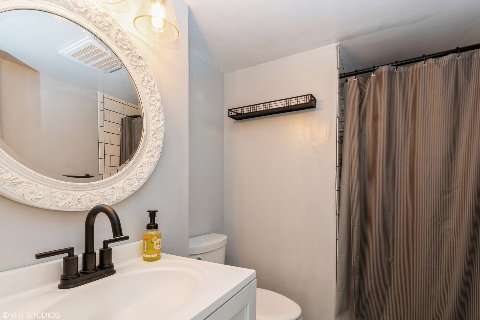 1555 Vincennes Street Crete, IL 60417 - Photo 10 of 18 a bathroom with a sink a toilet and a mirror