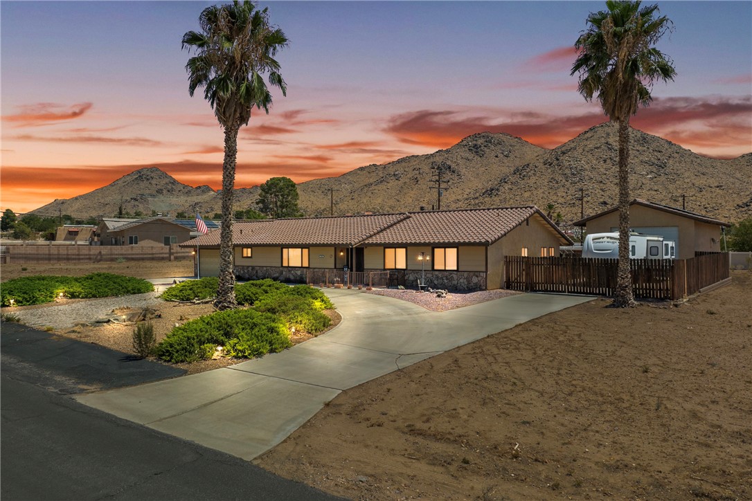 a front view of a house with a garden and yard